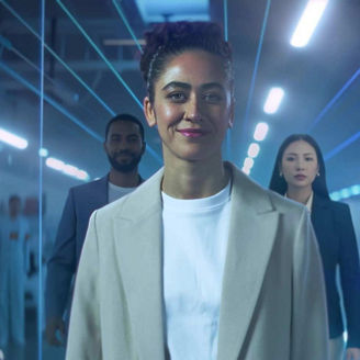 3 people in office with neon lines overlaid