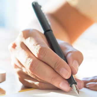Asian Business woman signing a contract document making a deal.