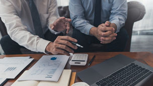 teamwork company meeting concept, business partners working with laptop computer together analysing startup financial project result or strategy plan and discussing data document in office