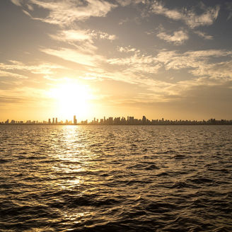 Belém city skyline buildings and Amazon River on a sunny summer day during sunset. Concept of environment, ecology, biodiversity, climate change, global warming, travel, tourism.