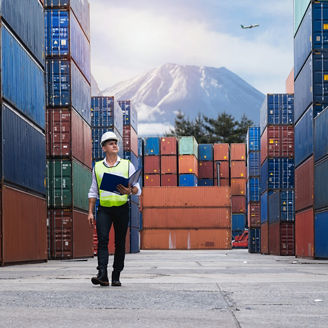 Foreman holding document, walking and checking the containers box from cargo ship for export and import