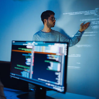 trainee developer hand up to ask speaker about software coding project presentation at night in office