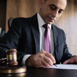 Judge or Legal advisor lawyer examining and signing legal documents.
