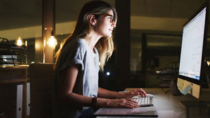 Shot of an attractive young businesswoman using a computer while working late in her office