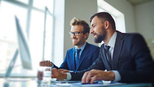 Businessmen working with computer in team