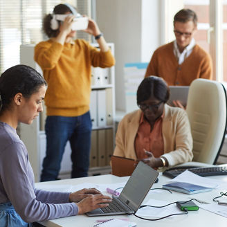 Side view portrait of female IT developer using laptop with code on screen while working in software production studio, copy space