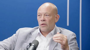 Chris Middlehurst talking into a microphone in a recording studio for The Insight in 15 podcast