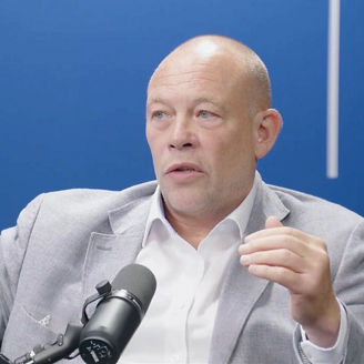 Chris Middlehurst talking into a microphone in a recording studio for The Insight in 15 podcast