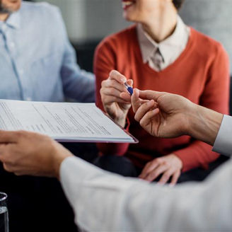 people signing a document 