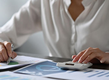 Hands working on documents on desk