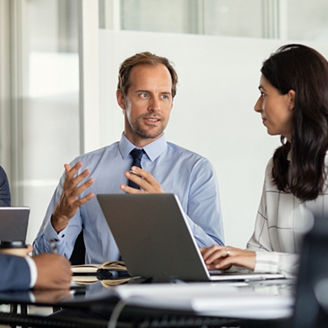 Three persons discussing in a room