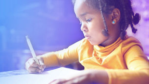 School child. African girl writing in notebook.