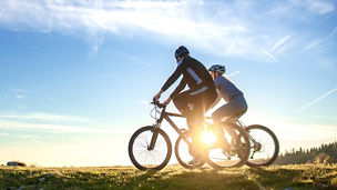 two people riding mountain bikes