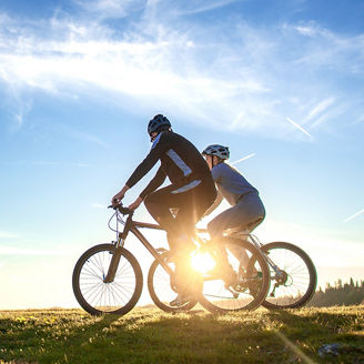 two people riding mountain bikes