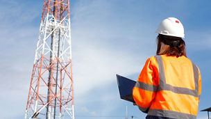 woman telecom tower