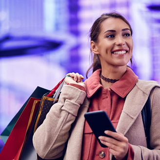 Woman smiling carrying shopping bag