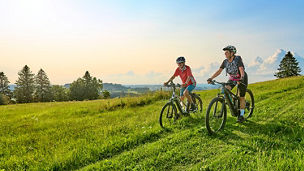 two-cyclists-downhill-grass