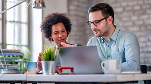 two people looking at laptop