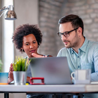 two people looking at laptop