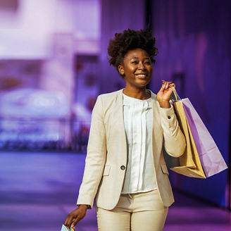 Outdoor shot of young woman using mobile phone outdoors in the city. Female business professional using smart phone in the city.