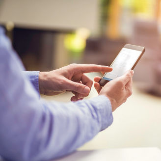 Unrecognisable man using remote control system on a smart phone, copy space.
