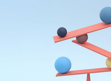 Three coral-colored beams balanced on a cone-shaped stand, with several colored spheres placed along the beams against a light blue background