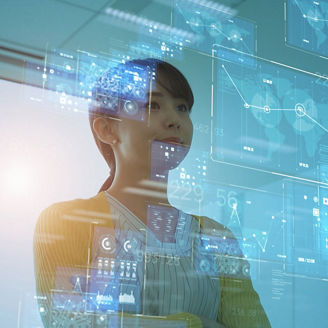 Person standing with arms crossed in front of multiple translucent digital screens displaying charts, graphs, and interface elements