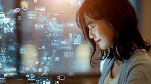 Asian woman watching hologram screens. Business and technology concept. Smart office. GUI (Graphical User Interface).