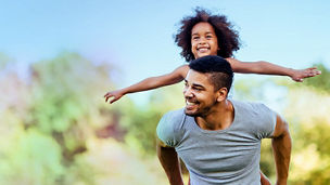 Joyful girl piggyback riding a man