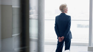 窓から外を眺める女性の後ろ姿