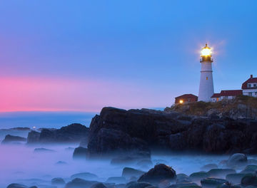 Early morning light reflects off clouds on  Portland Head Lighthouse