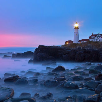 Early morning light reflects off clouds on  Portland Head Lighthouse