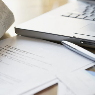 Newspaper pen and laptop