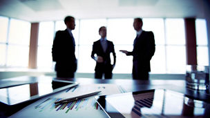 Colleagues meeting to discuss their future financial plans, only silhouettes being viewed