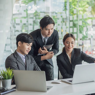 Young asian business people meeting and planning business strategies together in the office.