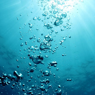 Bubbles undersea and sun rays.