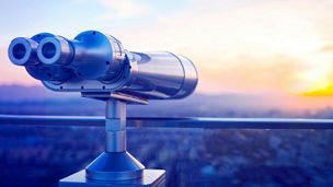 Binoculars or telescope on top of skyscraper at observation deck to admire the city skyline at sunset.Telescope located on the Beijing Olympic Tower