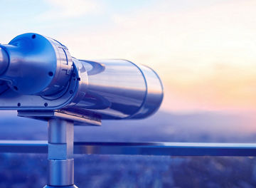 Binoculars or telescope on top of skyscraper at observation deck to admire the city skyline at sunset.Telescope located on the Beijing Olympic Tower
