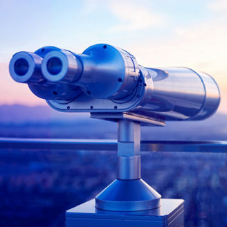 Binoculars or telescope on top of skyscraper at observation deck to admire the city skyline at sunset.Telescope located on the Beijing Olympic Tower
