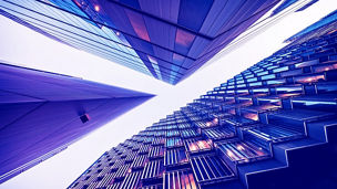 Highly detailed abstract wide angle view up towards the sky in the financial district of London City and its ultra modern contemporary buildings with unique architecture. Shot on Canon EOS R full frame with 10mm wide angle lens. Image is ideal for background. Toned image.