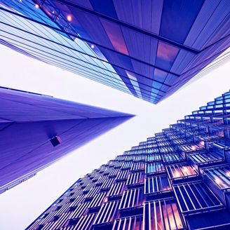 Highly detailed abstract wide angle view up towards the sky in the financial district of London City and its ultra modern contemporary buildings with unique architecture. Shot on Canon EOS R full frame with 10mm wide angle lens. Image is ideal for background. Toned image.