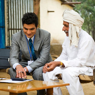 Financial advisor explaining to a farmer about agriculture loan, Hasanpur, Haryana, India