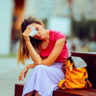 Person suffering from a heat wave taking a break on a bench