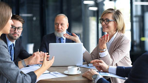 Portrait of a positive business employees at an office business meeting