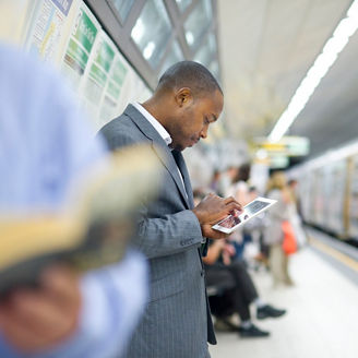 young man checking his emails in the subway