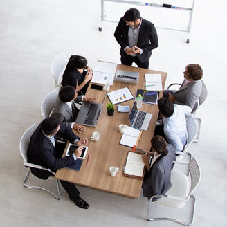 Top view of group of multiethnic busy people working in an office, Aerial view with businessman and businesswoman sitting around a conference table with blank copy space, Business meeting concept