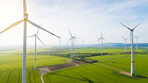 Aerial view of wind turbines and agriculture field