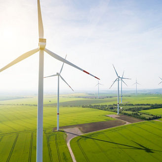 Aerial view of wind turbines and agriculture field