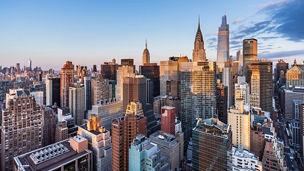 This high angle sunrise view from UN Plaza on the east side of Manhattan looks southwest over the Kips Bay neighborhood toward the Empire State Building, the Chrysler Building, and One Vanderbilt with Lower Manhattan and One World Trade Center in the distance.