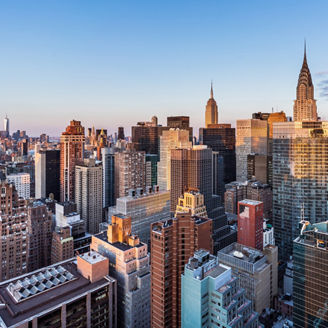 This high angle sunrise view from UN Plaza on the east side of Manhattan looks southwest over the Kips Bay neighborhood toward the Empire State Building, the Chrysler Building, and One Vanderbilt with Lower Manhattan and One World Trade Center in the distance.